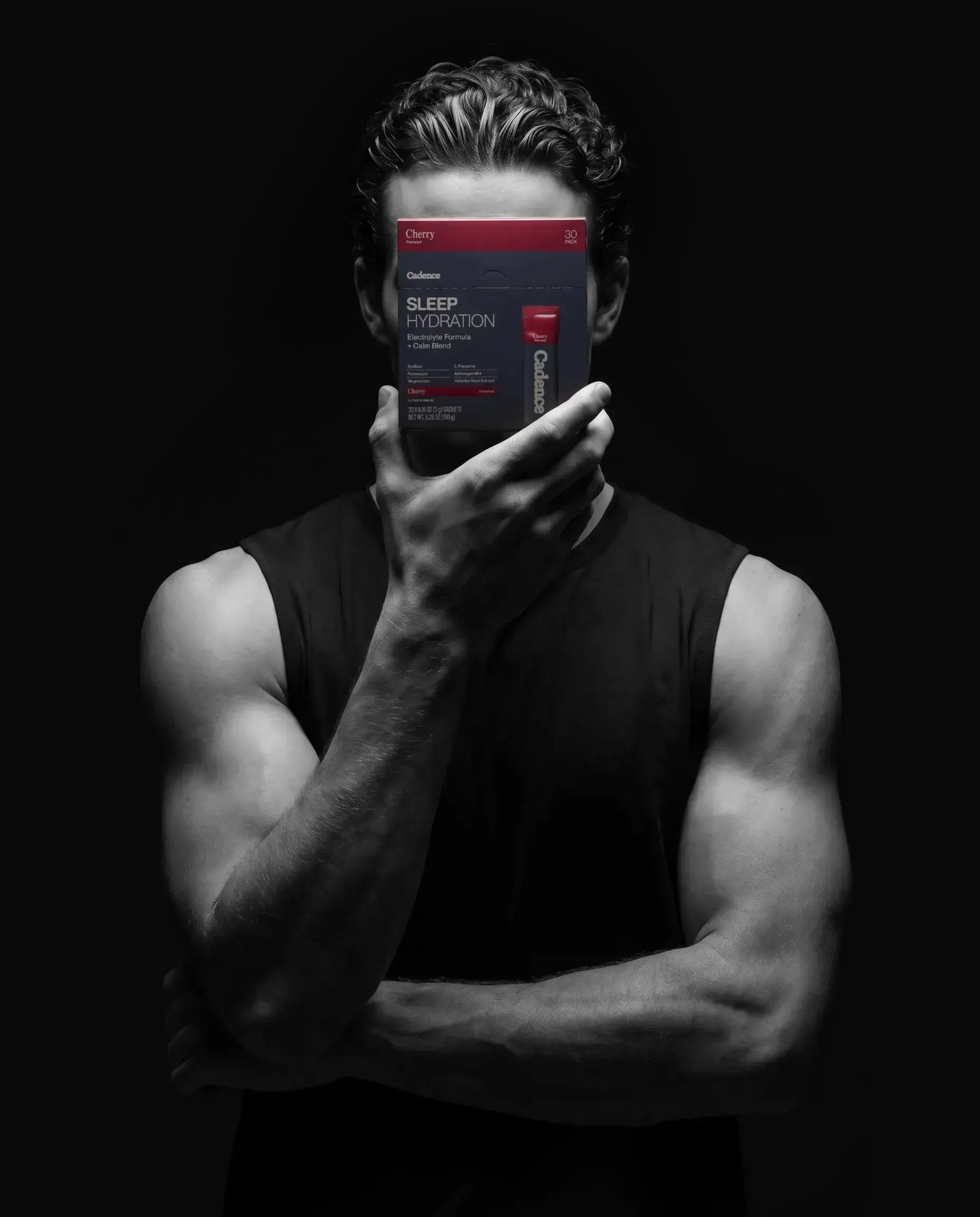 An athlete holding a phone showing the Cadence Sleep Hydration product page